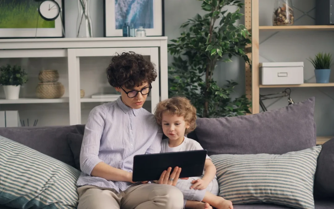 A parent and child looking at a tablet together.